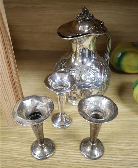 Three George V silver spill vases, height 11cm and a Victorian silver plated water jug